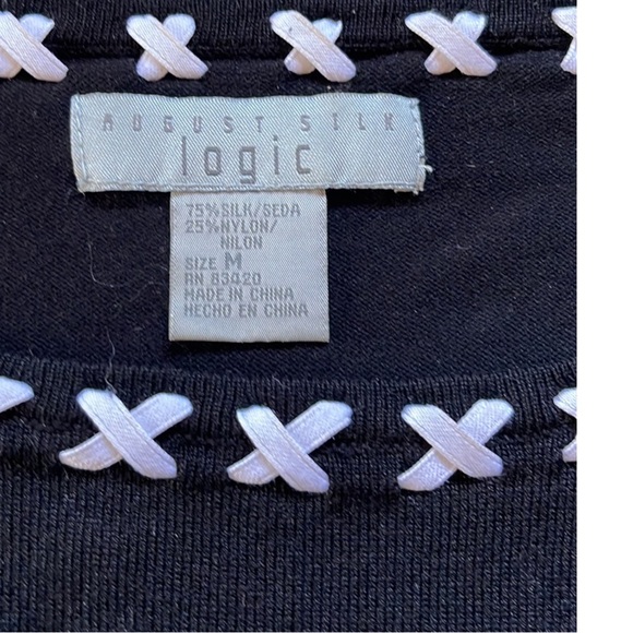 August Silk Logic black top. White criss crossed ribbons throughout neckline. - Picture 3 of 4
